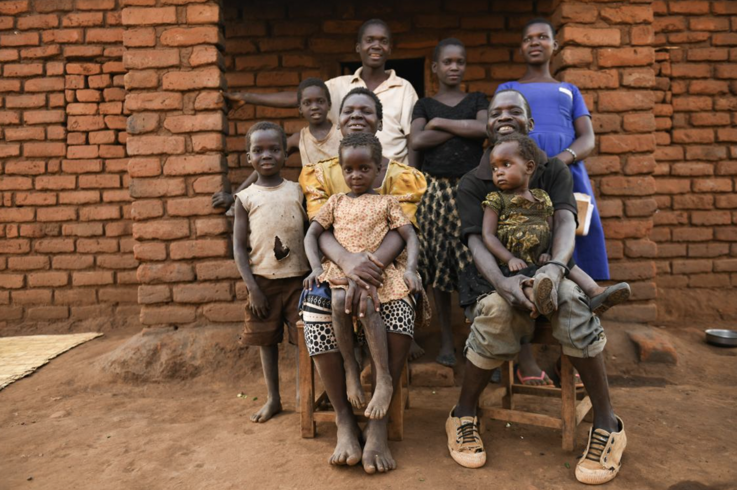 UNICEF Malawi/2020/Thoko Chikondi Sophie and her family outside their home in Balaka